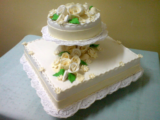 Tort z kwadratową podstawą 5 kg z biało- ekrii kwiatami i zielonymi listkami #wesele #tort #impreza #kościół
